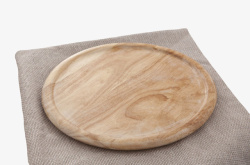 盛食物棕色木质纹理抹布上的圆木盘实物高清图片