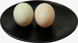 食品行业黑色盘装两枚土鸭蛋高清图片