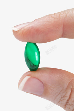 生物制药绿色胶囊治愈手捏着的西药片实物高清图片