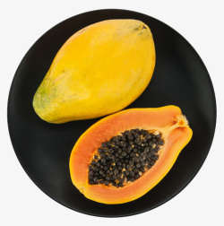 黄色营养在黑色碟子上的熟木瓜实素材