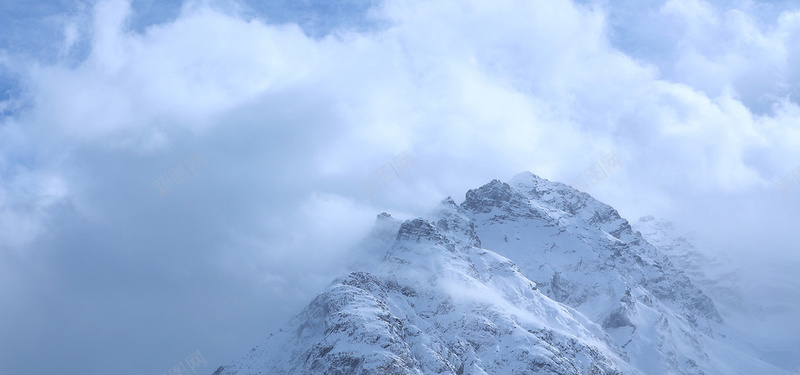 烟雾缭绕的高山雪峰摄影图片