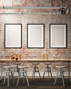 灰色装潢桌椅与墙上的空白画框高清图片