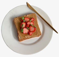 不锈钢餐刀盘子上放着一把金色餐刀和草莓土司高清图片