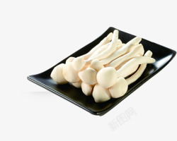 白玉菇黑色陶瓷盘里的蘑菇高清图片
