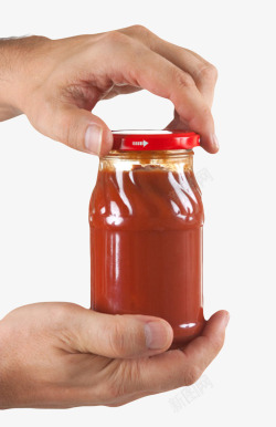 手拧透明瓶子手拧着玻璃番茄酱包装实高清图片